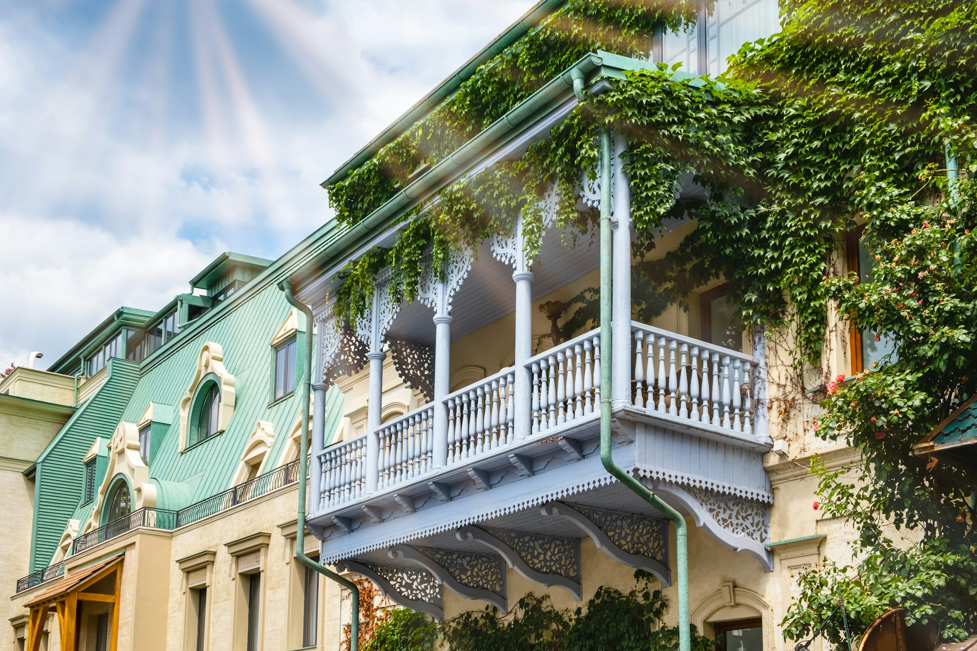 Carved wooden balcony and colorful buildings in historical Tbilisi, Georgia